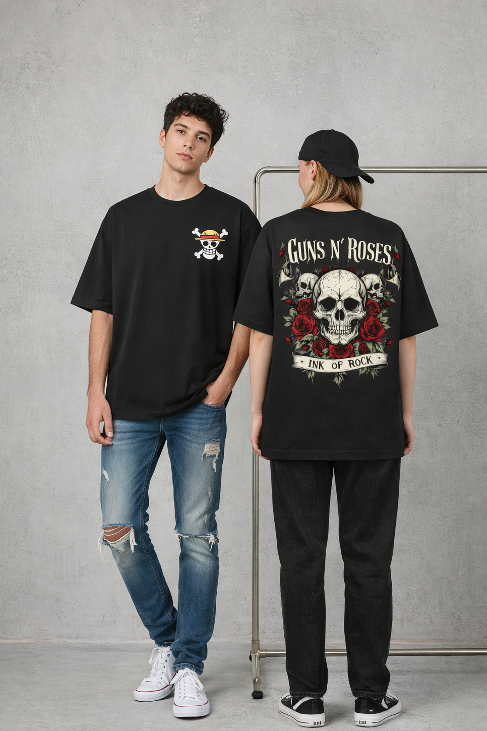 Two people wearing black t-shirts with graphic designs on a gray background